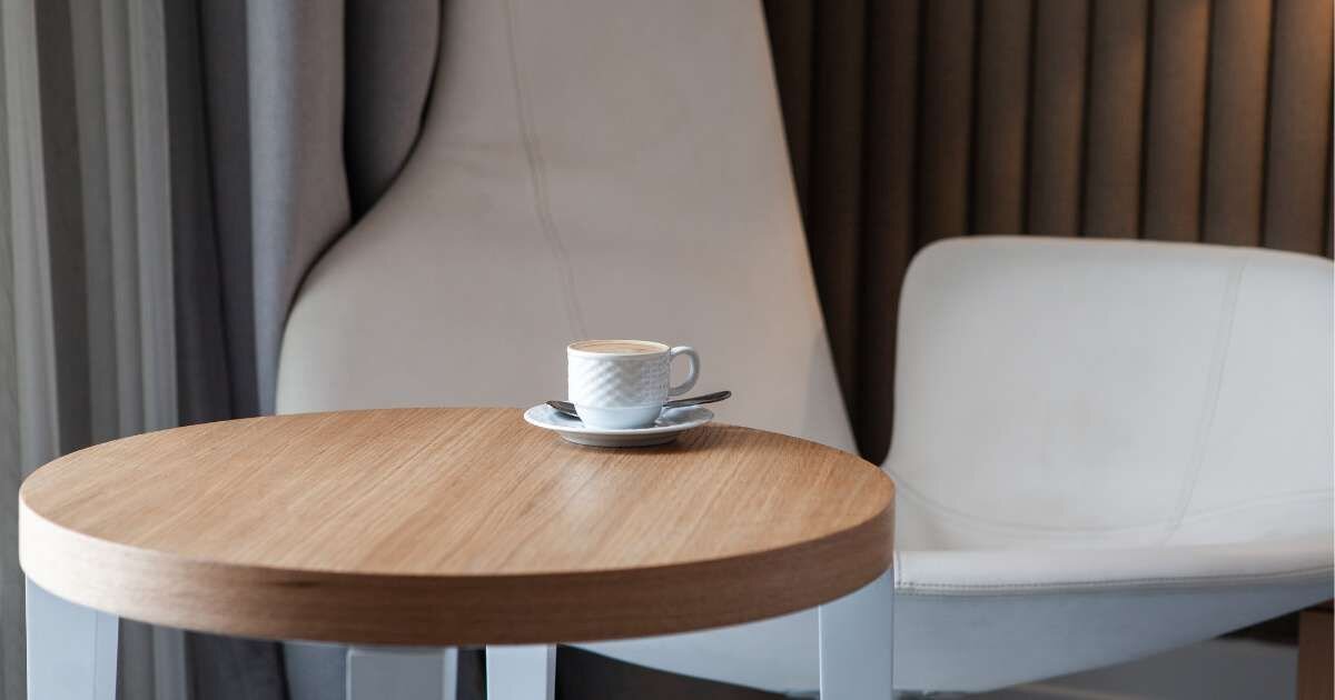 side table with a cup of coffee placed on top 